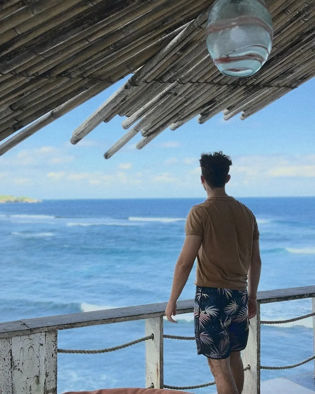 Francescomatteo guarda l'oceano da una terrazza